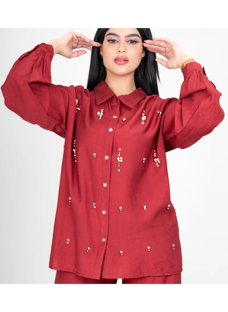 اكسا طقم عصري من قطعتين: بلوزة وبنطال بتفاصيل كريستالية